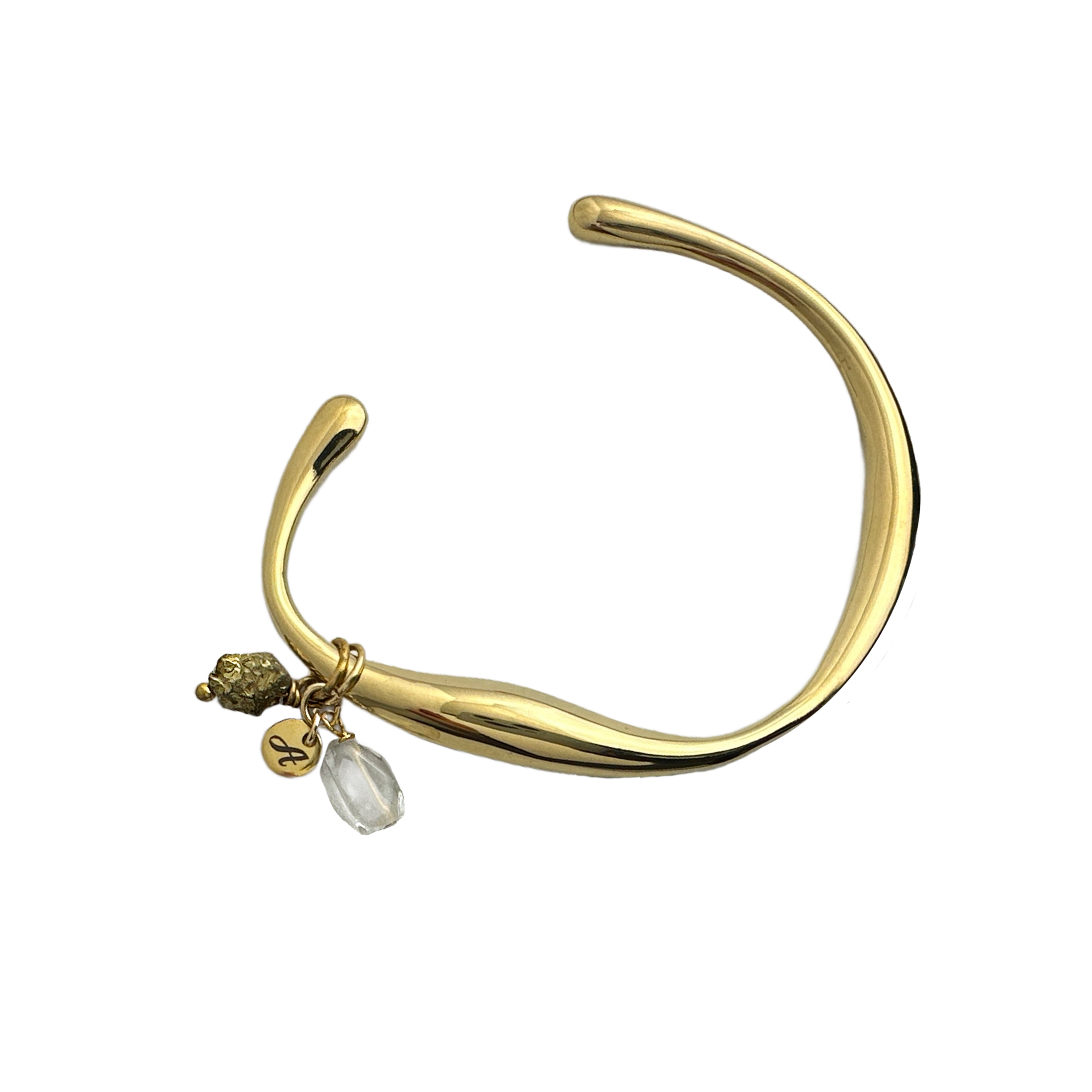 A slim gold-colored open cuff bracelet with a sleek asymmetric design and stone cluster embellishment. By Alysian