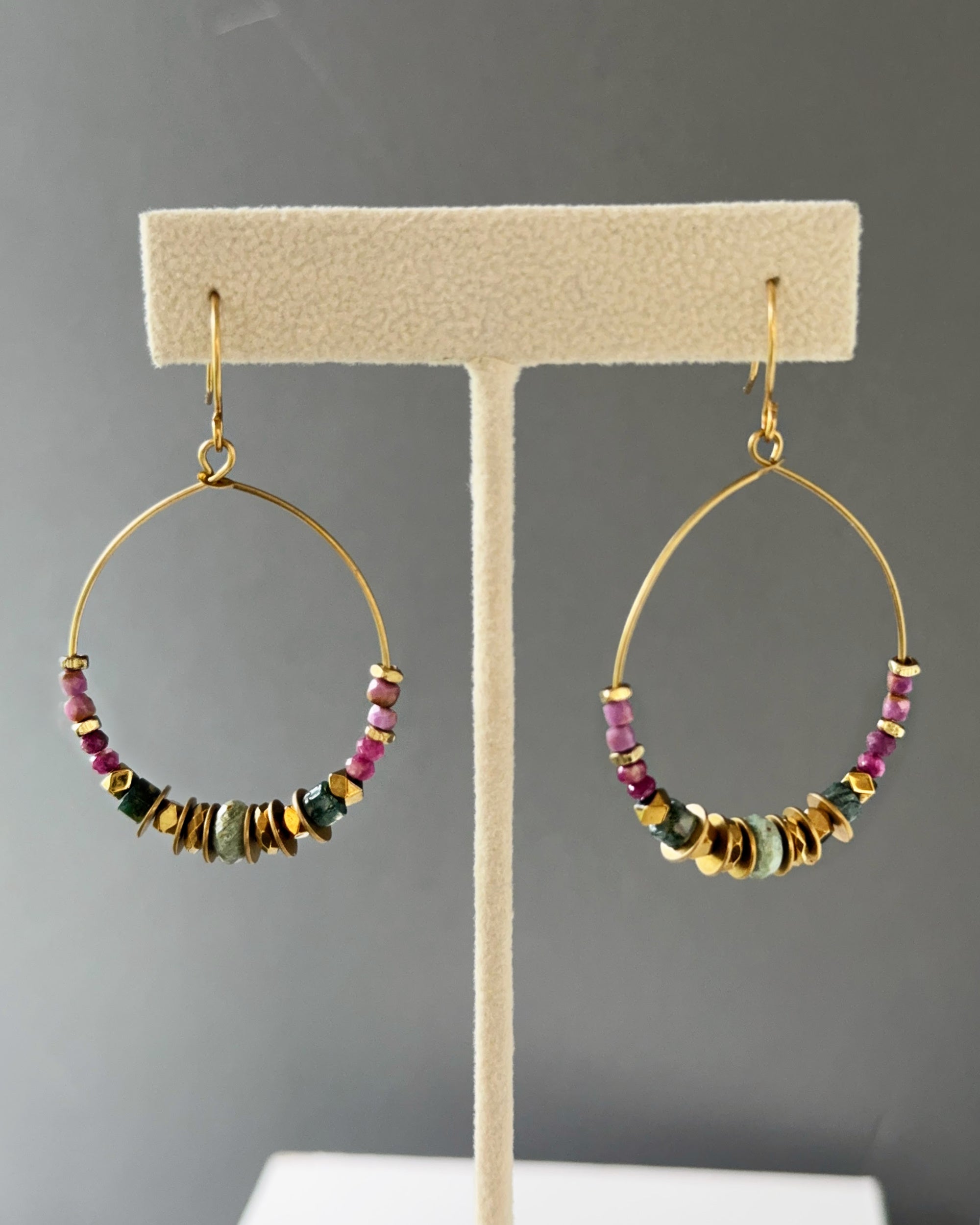 Brass hoop earrings with gemstones and edgy brass accents and boho-chic vibes shown on an earring stand — Mirelle Multistone hoop by Alysian.