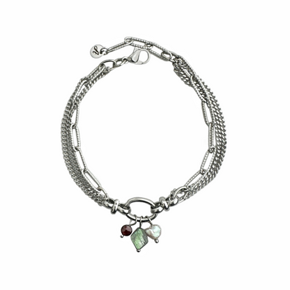A silver tone stainless steel bracelet of three rows of chain with a freshwater pearl and labradorite and garnet stones dangling from a center oval link. Handcrafted by Alysian.