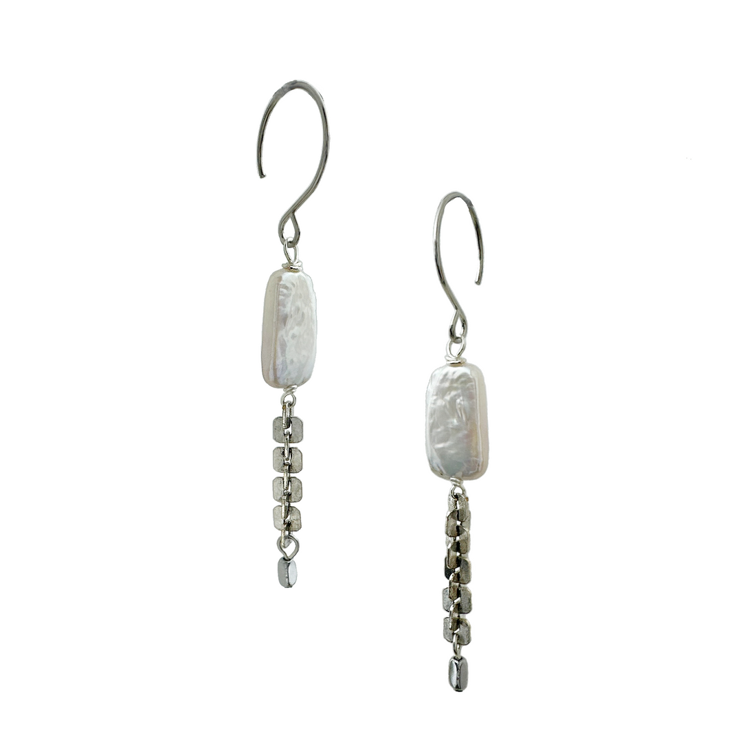 A pair of silver-tone earrings featuring rectangular freshwater pearls, antique silver-plated textural chain with silver-plated hematite stones and stainless steel ear wires. Handcrafted by Alysian. 