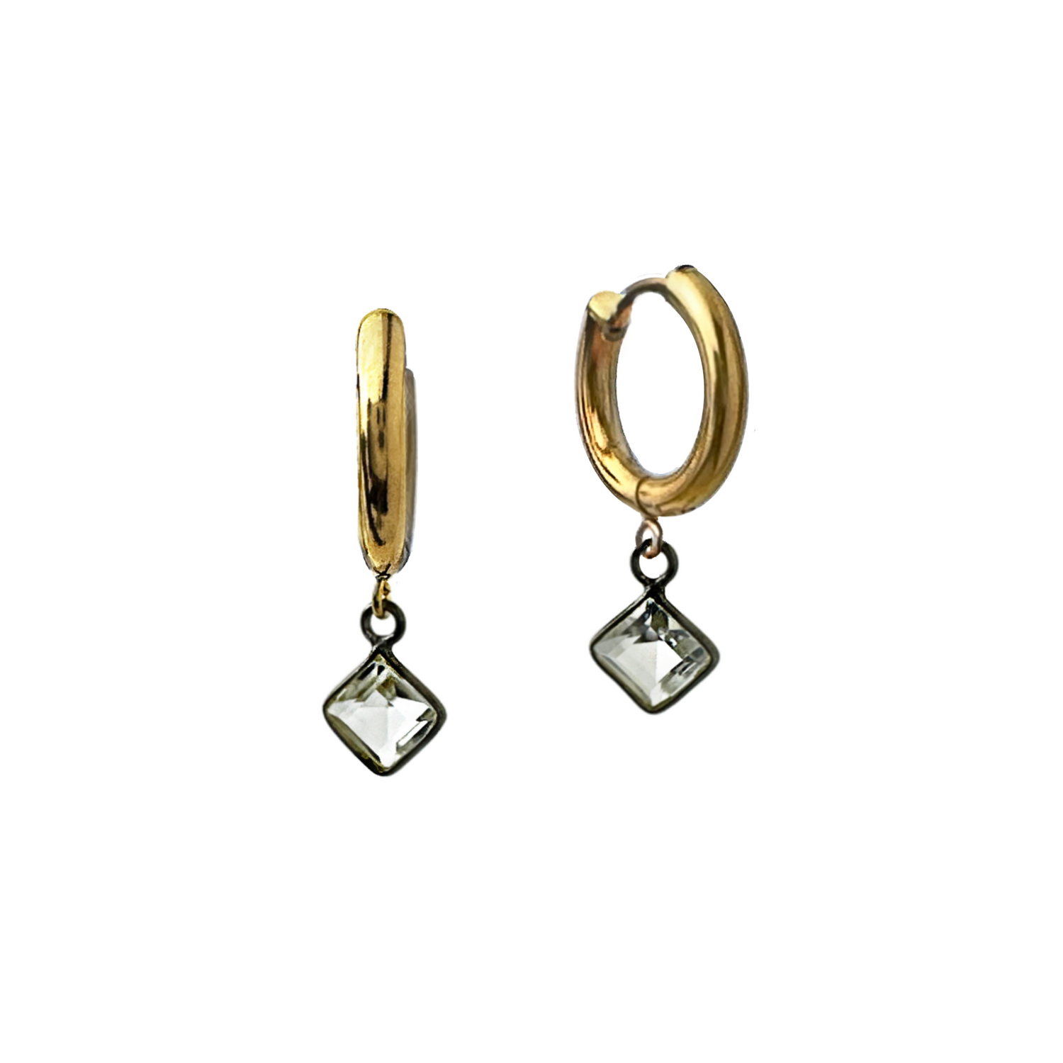 A mixed metal pair of gold-colored stainless steel huggie hoop earrings with drops of blackened sterling silver bezel-set crystal quartz stones in diamond shapes. By Alysian. 