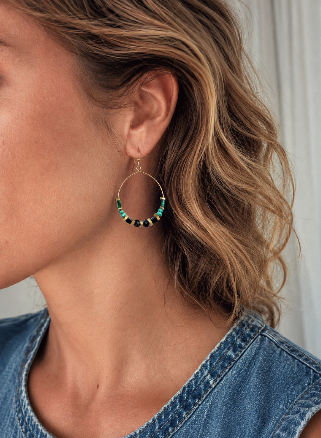 Close-up of a woman wearing the Adira Gemstone Hoop Earrings, handcrafted by Alysian.