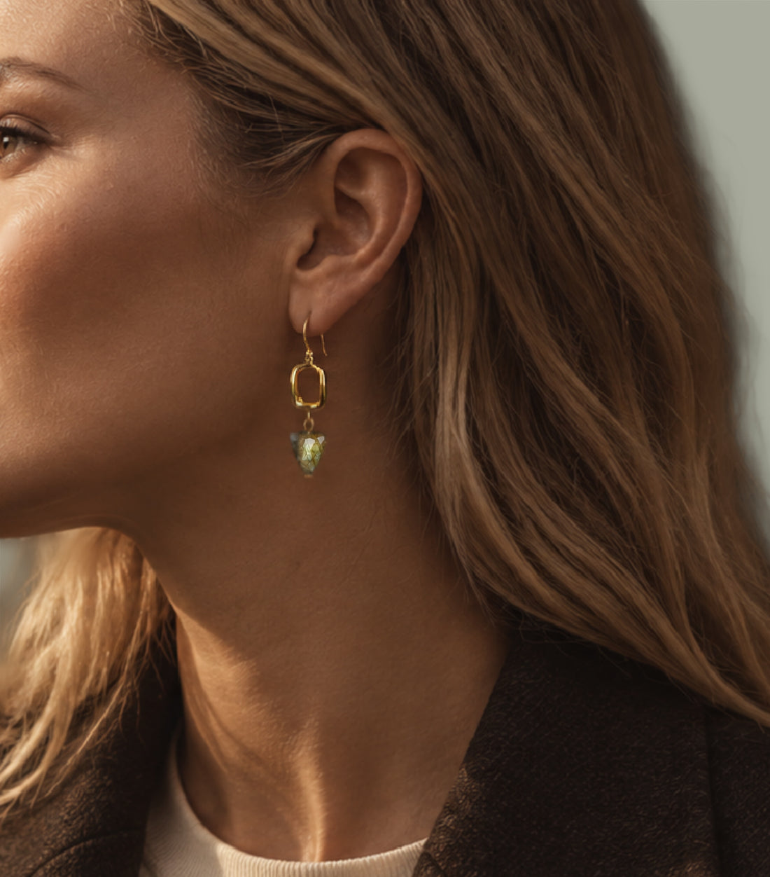 A close-up side profile of a woman wearing a Brynn Labradorite Earring – A handcrafted earrings by Alysian.