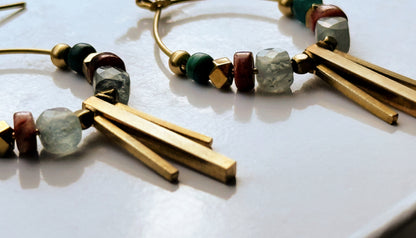 Close-up of a Soren Apatite Hoops, showing the details of gemstone beads and brass design elements. 