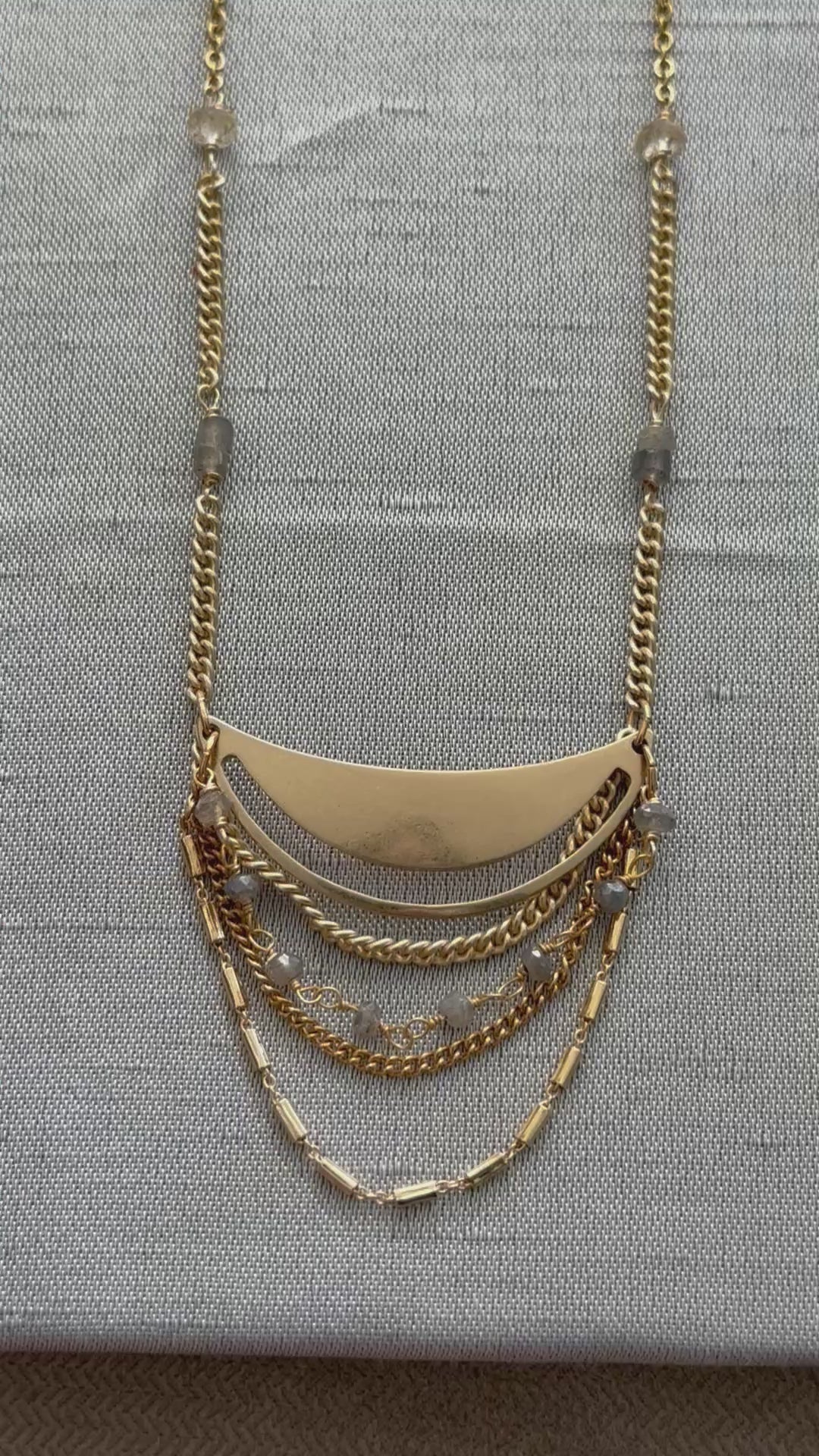 Gold Lusine adjustable crescent pendant necklace with draped chains and stones, one silver and one gold, on a luxe, close up, handcrafted by Alysian.