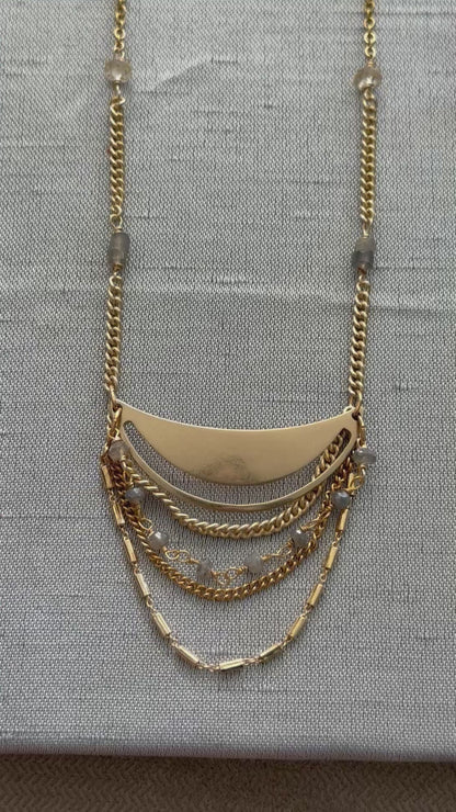 Gold Lusine adjustable crescent pendant necklace with draped chains and stones, one silver and one gold, on a luxe, close up, handcrafted by Alysian.